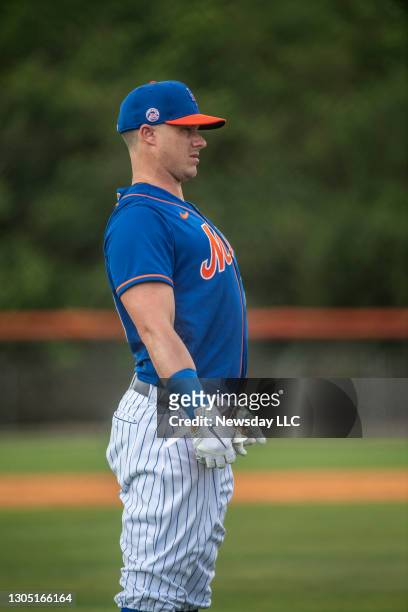 POrt St. Lucie, Florida: New York Mets catcher James McCann arches his back during a spring training workout In Port St. Lucie, Floria, on February...