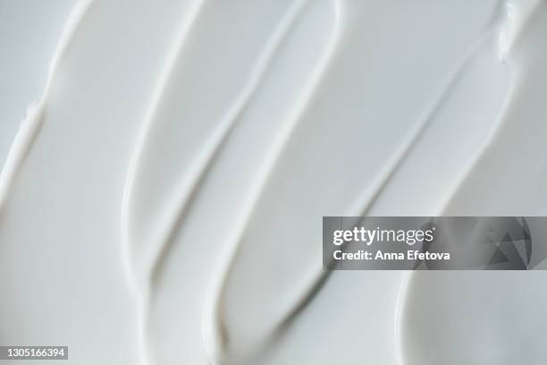 abstract and accurate texture of white cream. it may be self care concept or perfect food background. selfcare is a trendy procedure of the year. cosmetics banner with copy space - cremel photos et images de collection