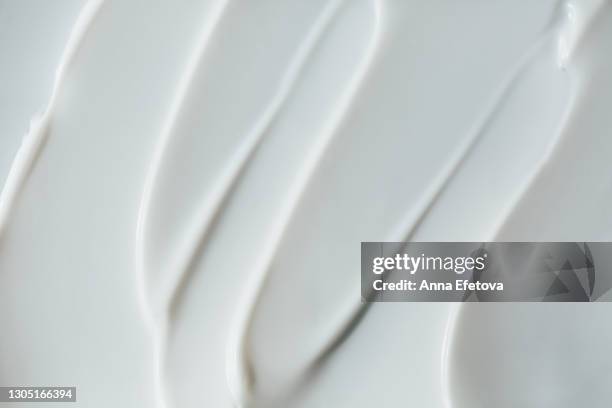 abstract and accurate texture of white cream. it may be self care concept or perfect food background. selfcare is a trendy procedure of the year. cosmetics banner with copy space - creme stock pictures, royalty-free photos & images