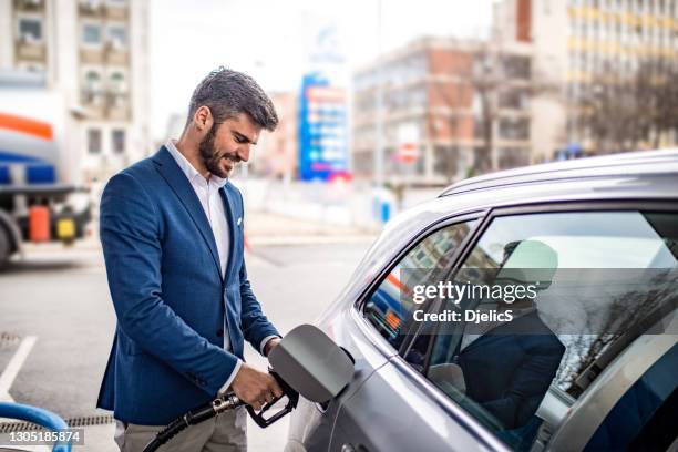 uomo felice al distributore di benzina. - fare il pieno di benzina foto e immagini stock