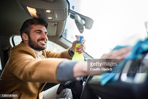 happy man cleaning his car interior. - wax stock pictures, royalty-free photos & images