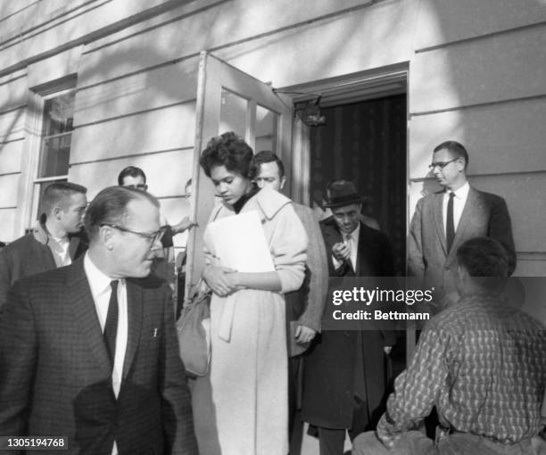 Charlayne Hunter, the first African American woman admitted to the University of Georgia, leaves the Registrar's Office on campus after being...