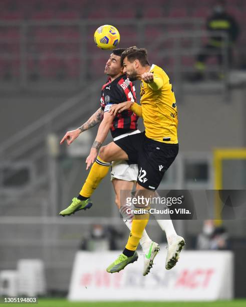Alessio Romagnoli of AC Milan and Fernando Llorente compete for the ball during the Serie A match between AC Milan and Udinese Calcio at Stadio...