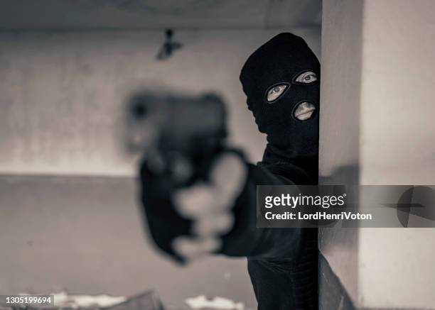 man with a mask holding gun - balaclava gun stock pictures, royalty-free photos & images