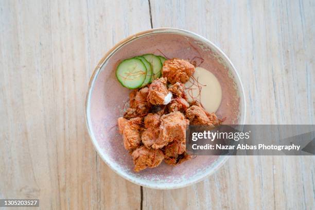 fried chicken in bow with sauce and cucumber. - fried chicken plate stock pictures, royalty-free photos & images