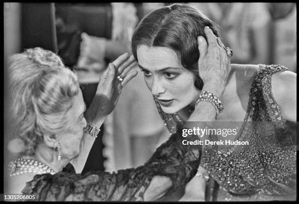 American actress Lois Chiles, a former fashion model, pictured on the film set of Death on the Nile having her hair adjusted by her co-star Bette...