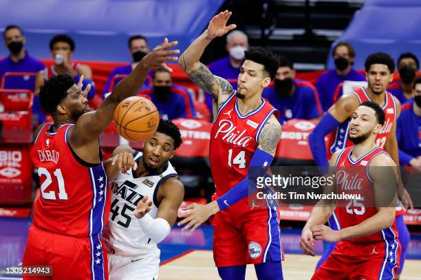 Donovan Mitchell of the Utah Jazz passes between Joel Embiid and Danny Green of the Philadelphia 76ers during the second quarter at Wells Fargo...