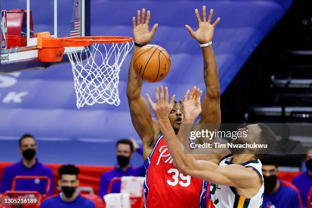 Rudy Gobert of the Utah Jazz drives past Dwight Howard of the Philadelphia 76ers during the second quarter at Wells Fargo Center on March 03, 2021 in...