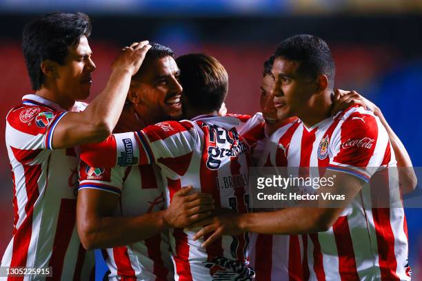 Miguel Ponce of Chivas celebrates with teammates after scoring the second goal of his team during the 9th round match between Queretaro and Chivas as...
