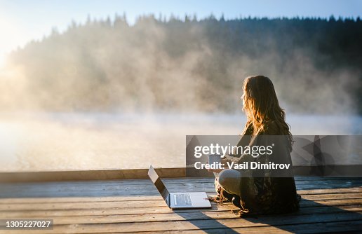 Woman Relaxing In Nature And Using Technology Woman Relaxing In Nature And Using Technology