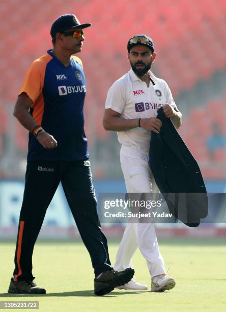 India Head Coach, Ravi Shastri talks to captain Virat Kohli prior to Day One of the 4th Test Match between India and England at the Narendra Modi...