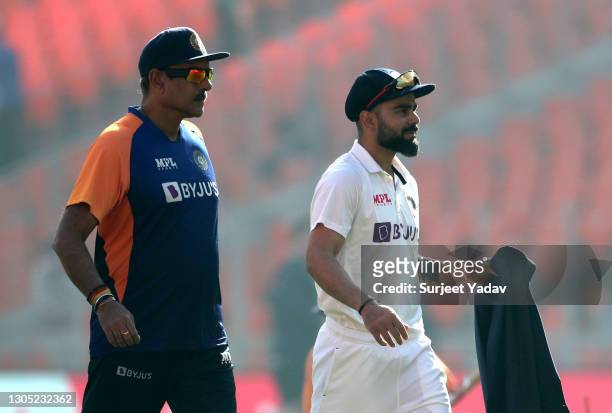 India Head Coach, Ravi Shastri talks to captain Virat Kohli prior to Day One of the 4th Test Match between India and England at the Narendra Modi...