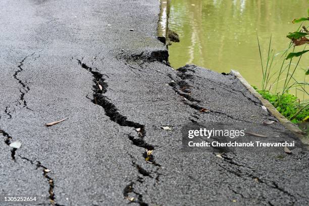 asphalt road cracked and collapsed - earthquake road stock pictures, royalty-free photos & images