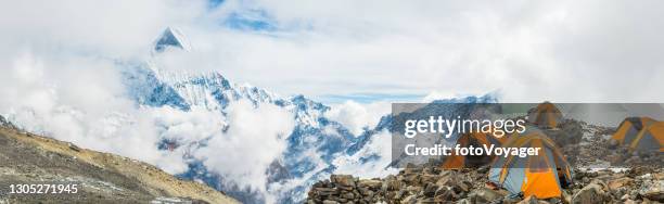 mountain tents base camp high in annapurna himalayas panorama nepal - base camp stock pictures, royalty-free photos & images