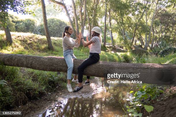 teenage girls enjoying a carefree day outdoors surrounded by lush nature. - sketch comedy stockfoto's en -beelden