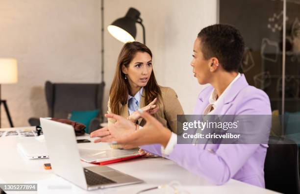 two businesswoman having an argument - irritation stock pictures, royalty-free photos & images