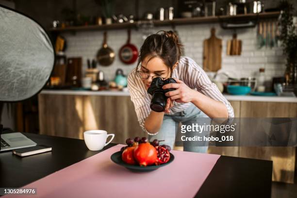 food photographer taking a photo of fruit - food photography stock pictures, royalty-free photos & images