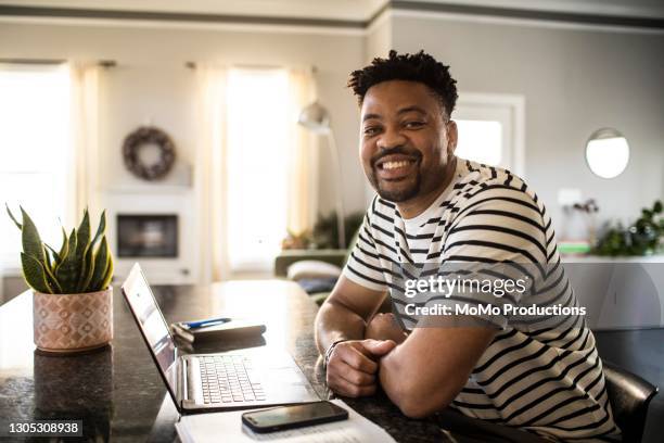 portrait of man working from home - black man laptop foto e immagini stock