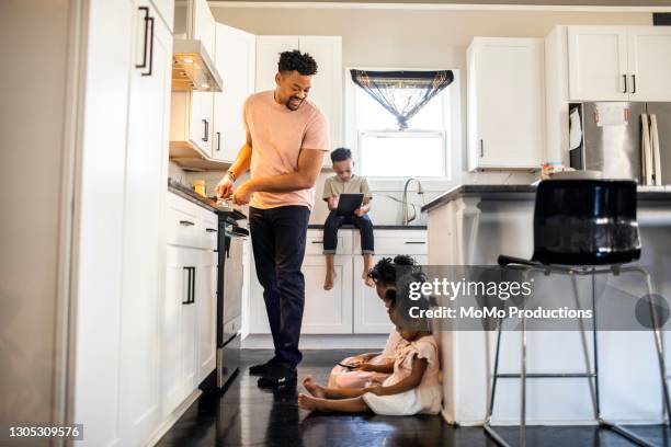 father cooking breakfast for children - cooking breakfast stock pictures, royalty-free photos & images