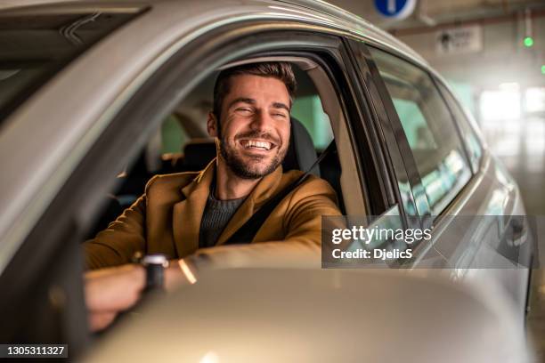 man driving a car in public garage. - looking out car window stock pictures, royalty-free photos & images