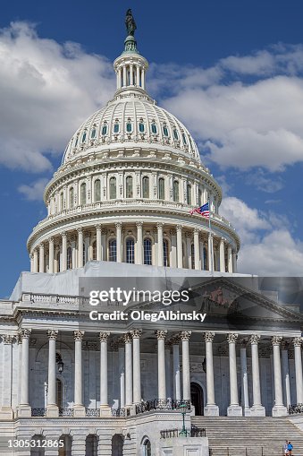 East Façade of the US Capitol Building with Blue sky and Puffy Clouds, Washington DC, USA.