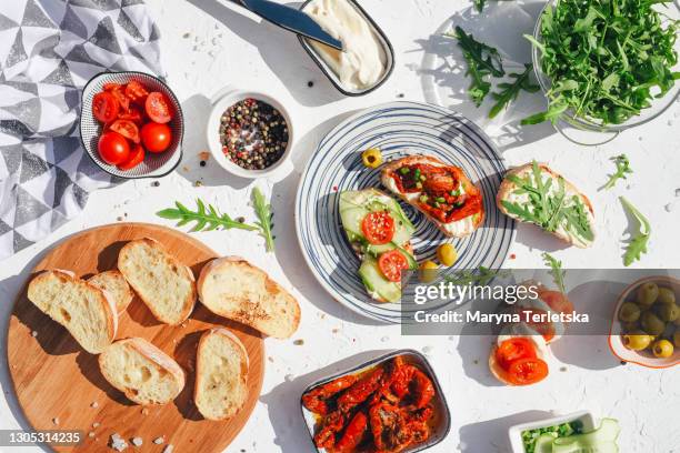 a variety of healthy toasts with vegetables, seeds and microgreens. - chopped tomatoes foto e immagini stock