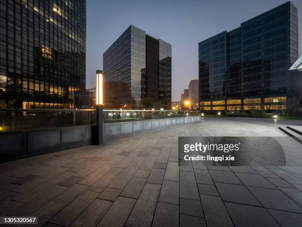 facades of modern buildings in the business district of hangzhou, china in the evening - dunkel stock-fotos und bilder