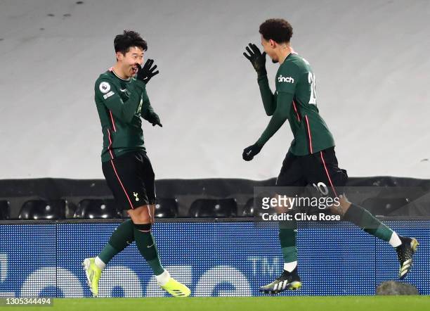 Dele Alli of Tottenham Hotspur celebrates with teammate Son Heung-Min after scoring his team's first goal during the Premier League match between...