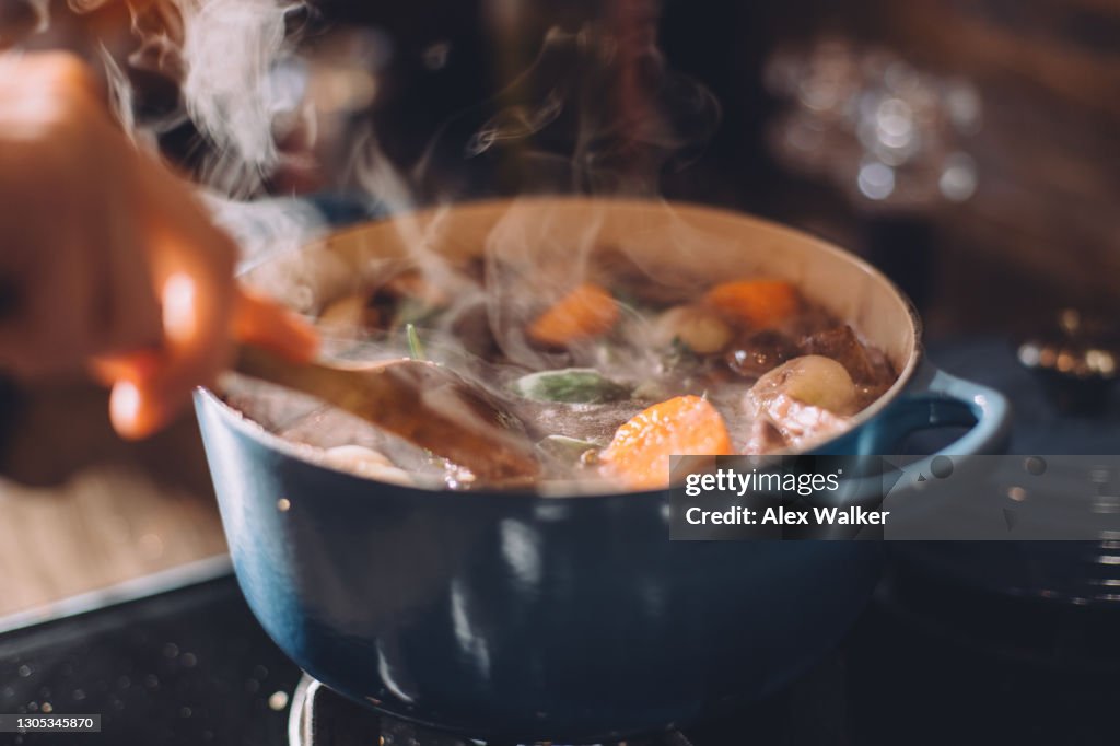 Steaming stew in blue cast iron pot on stove