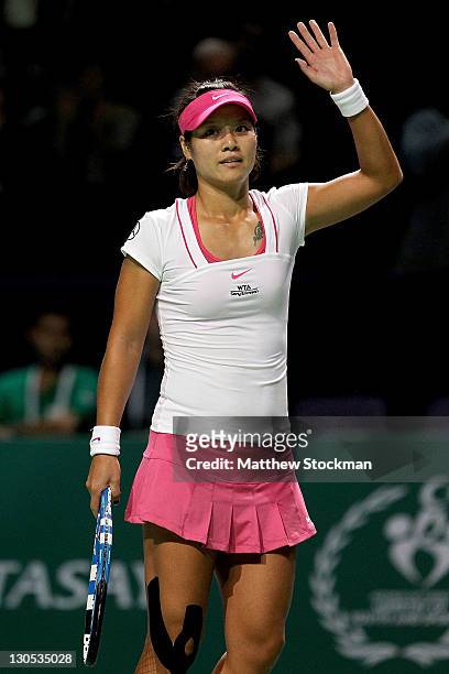 Na Li of China acknowledges the crowd after her win over Maria Sharapova of Russia during round robin play of the TEB BMP Paribas WTA Championships...
