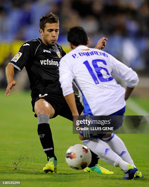 Valencia's defender Jordi Alba vies with Zaragoza's Paraguayan midfielder Pablo Barrera during the Spanish League football match between Zaragoza and...