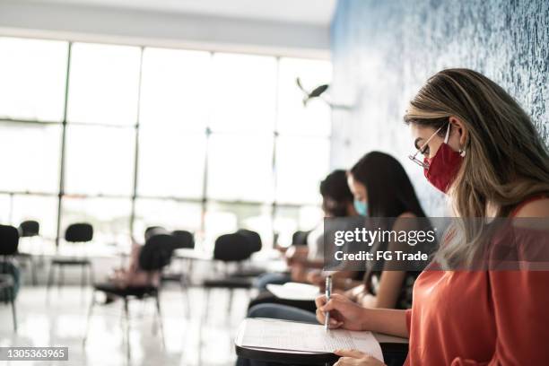 people taking tests during job interview or a test on a university - wearing face mask - employee engagement survey stock pictures, royalty-free photos & images