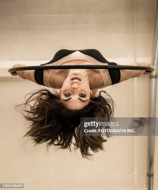 female aerial dancer on the hoop - gymnastics equipment stock pictures, royalty-free photos & images