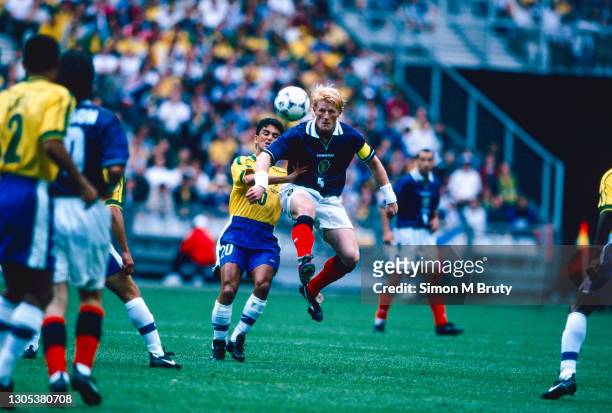 Colin Hendry of Scotland and Bebeto of Brazil in action during the World Cup group stage match between Brazil and Scotland at the Stade de France on...