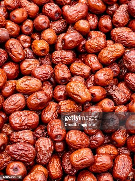 an abstract pattern of irregularly stacked red dates - date fruit stock pictures, royalty-free photos & images