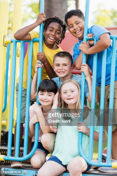 girl with down syndrome, friends at playground - children only stock pictures, royalty-free photos & images