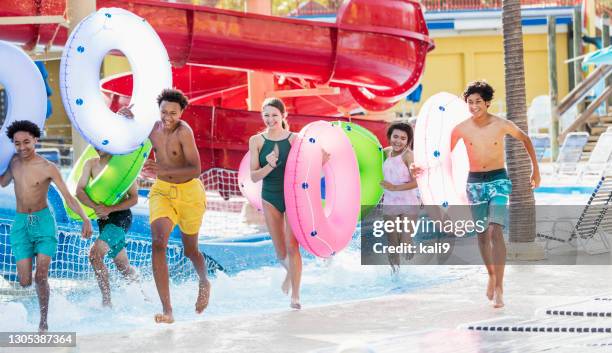 teenagers at water park entering lazy river - lazy river stock pictures, royalty-free photos & images