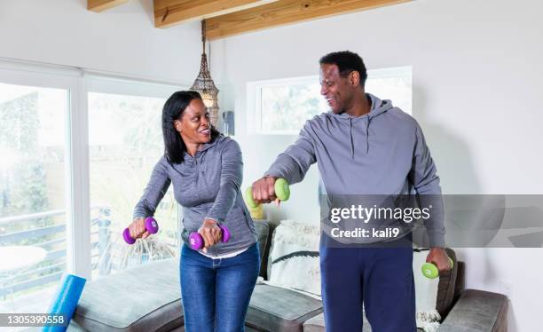 mature black couple working out at home together - hand weight stock pictures, royalty-free photos & images