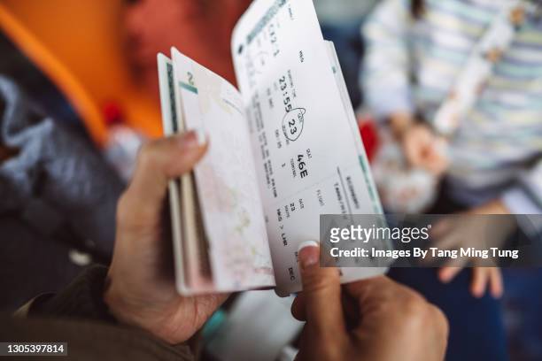 cropped shot of a female traveller checking her boarding pass & passport at the boarding gate in the airport - emigration and immigration stock pictures, royalty-free photos & images