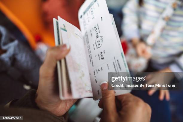 cropped shot of a female traveller checking her boarding pass & passport at the boarding gate in the airport - migration bildbanksfoton och bilder