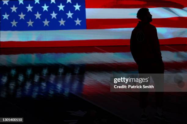 Anthony Gill of the Washington Wizards stands during the U.S. National Anthem before playing against the Los Angeles Clippers at Capital One Arena on...