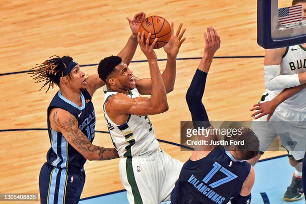 Giannis Antetokounmpo of the Milwaukee Bucks goes to the basket against Brandon Clarke of the Memphis Grizzlies during the first half at FedExForum...