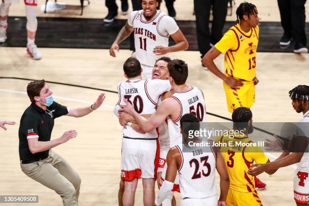 Student manager Ty Larson of the Texas Tech Red Raiders celebrates with forward Marcus Santos-Silva following a win against the Iowa State Cyclones...