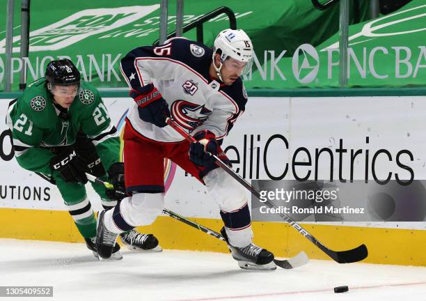Michael Del Zotto of the Columbus Blue Jackets skates the puck against Jason Robertson of the Dallas Stars in the first period at American Airlines...