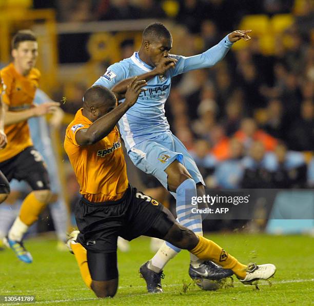 Wolverhampton Wanders's George Elokobi tackles Manchester City's Abdul Razak during their League Cup fourth round football match at Molineux...