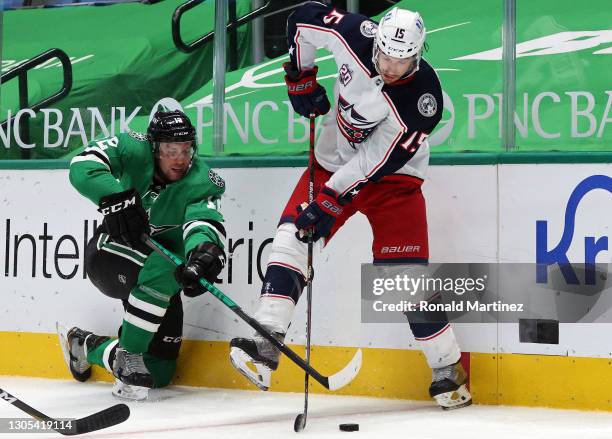 Michael Del Zotto of the Columbus Blue Jackets skates the puck against Radek Faksa of the Dallas Stars in the third period at American Airlines...