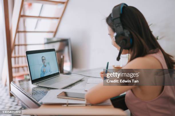 close up sideview asian chinese beautiful woman having discussion with her lecturer online with laptop and headset at home - teacher taking attendance stock pictures, royalty-free photos & images