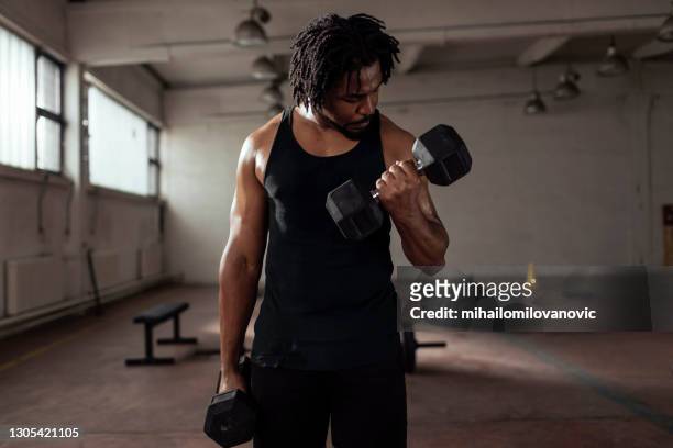 working on his biceps - bent stock pictures, royalty-free photos & images