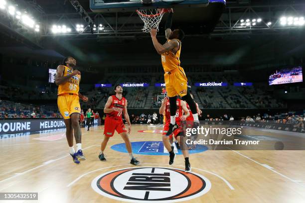 Orlando Johnson of the Bullets dunks the alley-oop passes the ball from Victor Law during the NBL Cup match between the Perth Wildcats and the...