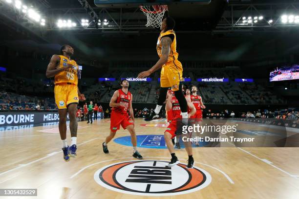 Orlando Johnson of the Bullets dunks the alley-oop passes the ball from Victor Law during the NBL Cup match between the Perth Wildcats and the...